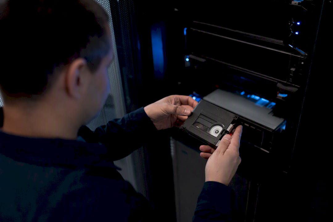Hands handling backup tape in data center