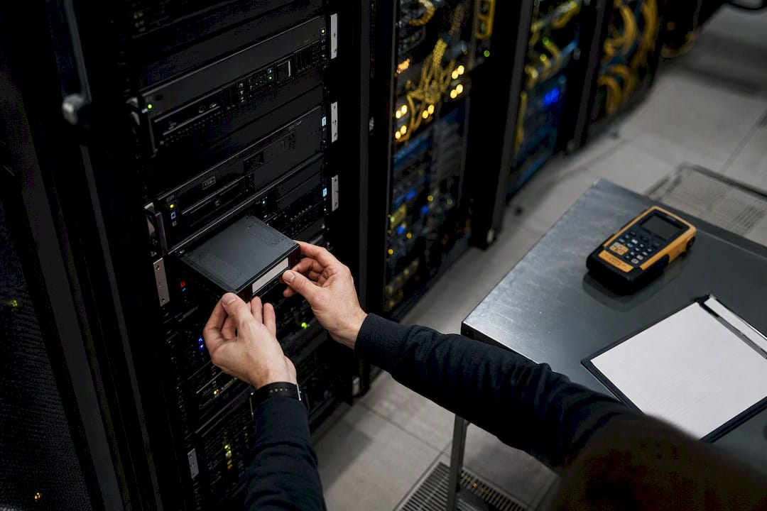 Technician inserting backup tape cartridge