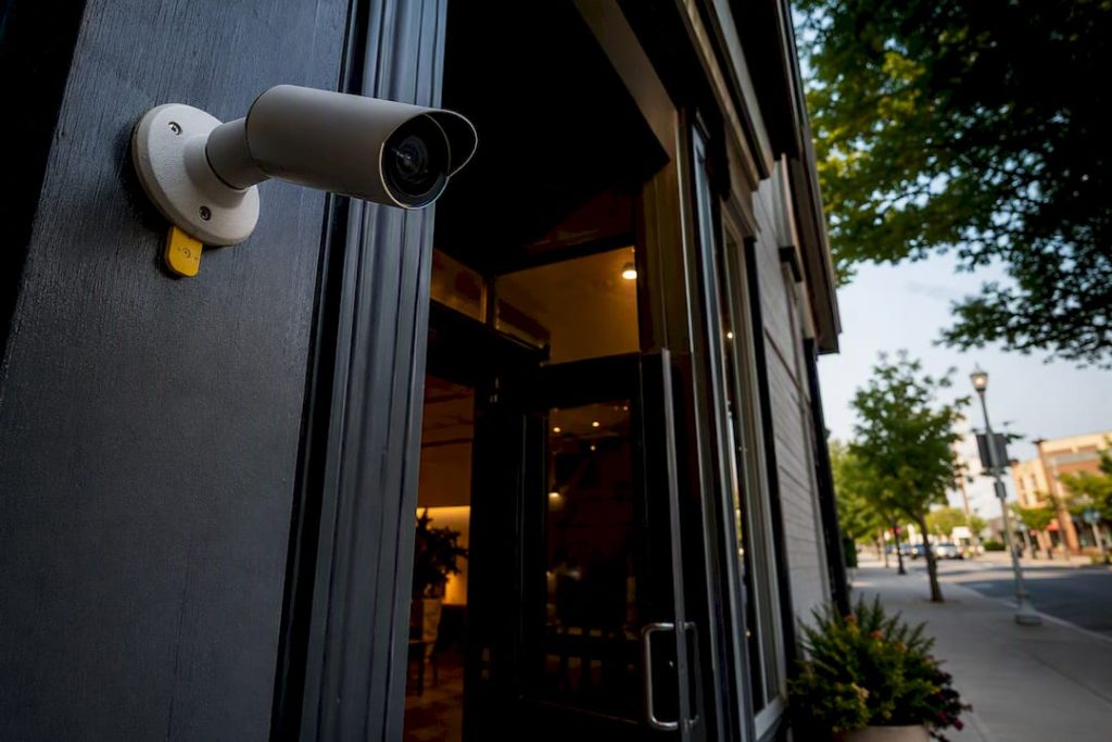 Anonymous security camera watching business entrance